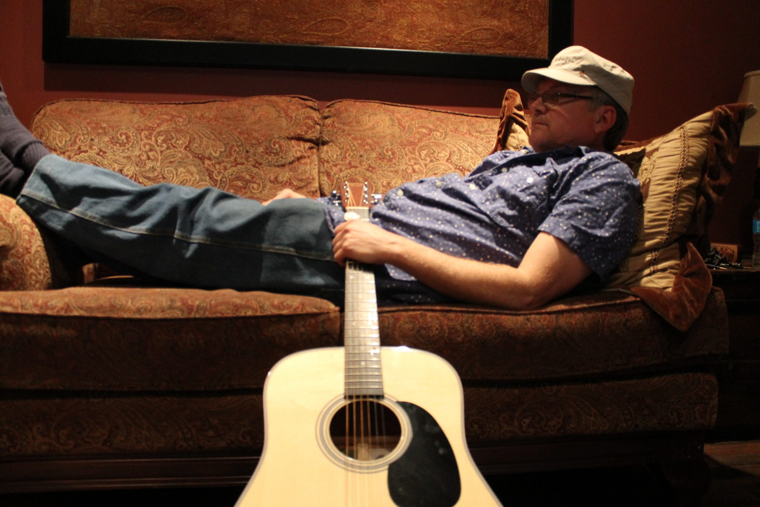 John Watson on Couch with Guitar
